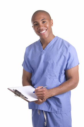 Photo of a person wearing blue scrubs and holding a clipboard